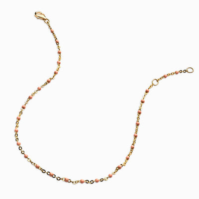 An Awe Inspired colored enamel anklet with coral beads.