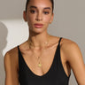 The model is wearing a black tank top and Awe Inspired's Hedone Pendant.
