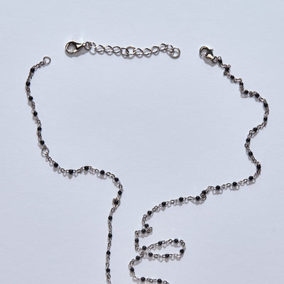 An Awe Inspired silver necklace extender with a chain and a pendant.