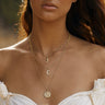 Model wearing Diamond Moon Amulet layered with standard Selene pendant in gold vermeil