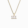 The Angel Number Necklace by Awe Inspired is a gold necklace featuring a pendant with the number "111" arranged vertically, adorned with small clear crystals, symbolizing new beginnings and balance and harmony.