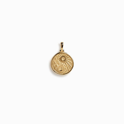 A Cosmic Yin Yang Amulet pendant with a sun on it by Awe Inspired.