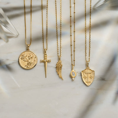 Collection of Awe Inspired jewelry including the Moonstone Amulet Necklace in gold vermeil
