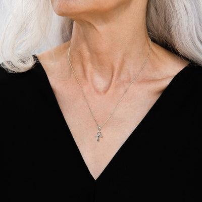 A woman with gray hair wearing an Awe Inspired Ankh Amulet necklace.