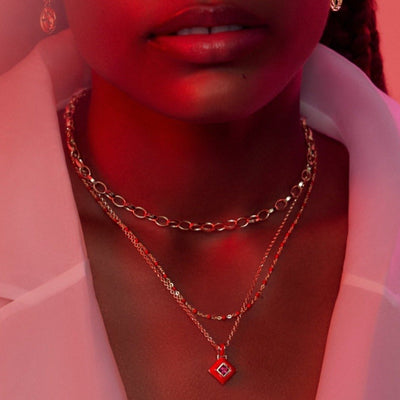 Model wearing Red Aura amulet with ruby gemstone in gold vermeil