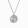 Awe Inspired's Aphrodite Necklace features a silver pendant adorned with a circular medallion, intricately engraved with an abstract human figure, capturing the sensual essence of the Goddess of Love.