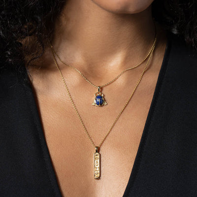 A woman wearing an Awe Inspired Lapis Lazuli Scarab Amulet necklace.