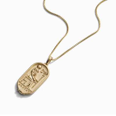An Awe Inspired Bastet Tablet pendant with an image of an Egyptian pharaoh.