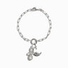 Calm the Chaos Charm Bracelet by Awe Inspired, a silver chain Charm Collector Bracelet adorned with a crescent moon, bird, and two teardrop charms; secured by a lobster clasp.