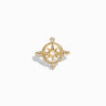 The Compass Rose Ring by Awe Inspired features a striking gold design with a mother of pearl center, showcasing a star-shaped motif accented by small diamonds at three points.