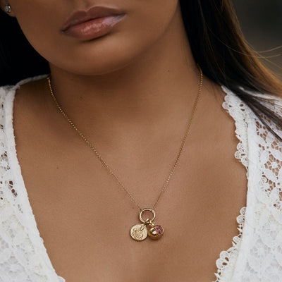Model wearing Amulet Collector Necklace paired with mini Persephone pendant and pomegranate amulet in gold vermeil
