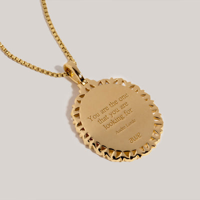 An Erzulie Pendant by Awe Inspired with a quote on it.
