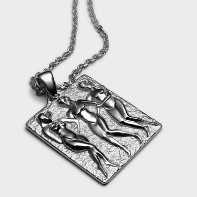 An Embrace Tablet necklace with two women on it, by Awe Inspired.