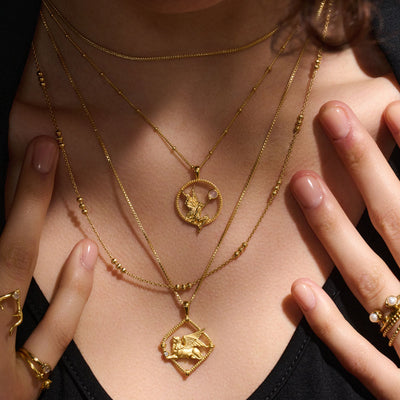 A woman wearing Awe Inspired's Nymph Pendant and rings.