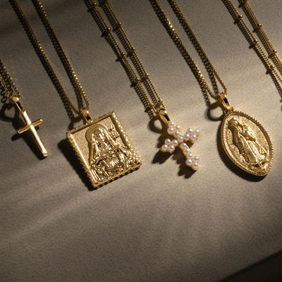 A group of Awe Inspired Pearl Cross Amulets with crosses on them.