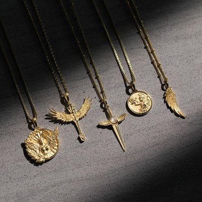A group of Awe Inspired Wing Amulet necklaces with wings and coins on them.