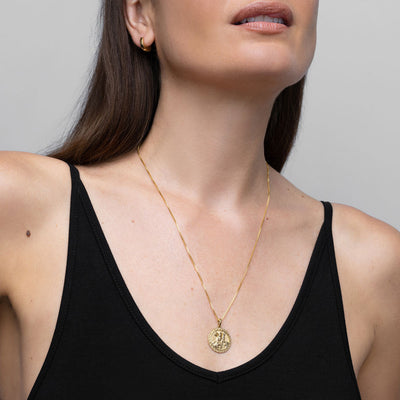 A woman wearing a black tank top with an Awe Inspired Frigg Pendant necklace.
