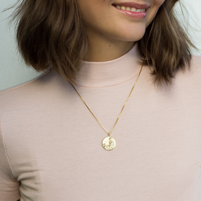 Model wearing standard round Marie Curie pendant