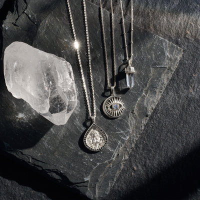 Ala pendant on cable chain paired with Watchful Mooneye amulet on a box chain and Crystal Quartz amulet on a saturn chain in sterling silver