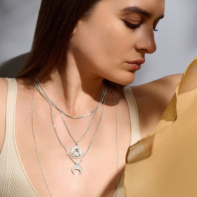 A woman wearing an Awe Inspired Cube Chain Necklace.