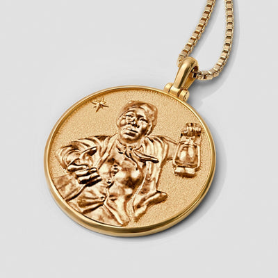 An Awe Inspired Harriet Tubman Pendant necklace with an image of a man playing a guitar.