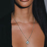 A woman wearing an Iris Pendant necklace from Awe Inspired.