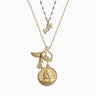 Reach new heights with the Awe Inspired Necklace Set, featuring three layered gold necklaces: a "LOVE" pendant, a small gold bird adorned with crystal details, and a round coin pendant engraved with a profile. Celebrate the women's suffrage movement with this timeless piece that effortlessly combines history and elegance.