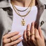 A woman wearing an Awe Inspired Embrace Tablet necklace and ring.