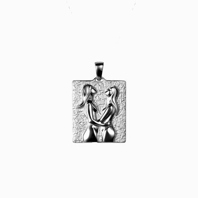 An Embrace Tablet necklace from Awe Inspired with a woman and a man on it.
