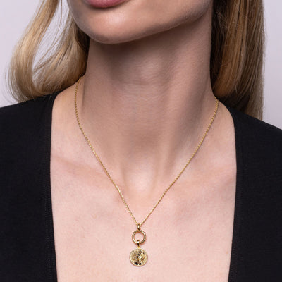 Model wearing the Mini Round Amulet Collector Link with mini Medusa pendant in gold vermeil