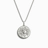 The Medusa Necklace by Awe Inspired is a silver accessory adorned with a round pendant that showcases an intricate Medusa head design, symbolizing resilience and protection.