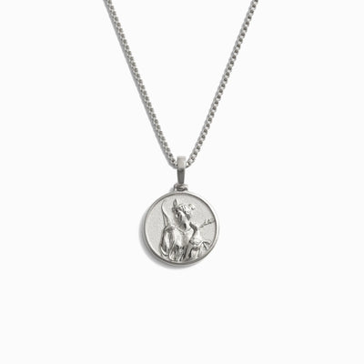 Awe Inspired's Mini Artemis Necklace is a silver accessory that boasts a circular pendant engraved with the image of Artemis, the fierce protector and goddess of the wild.