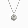 The Mini Brigid Necklace by Awe Inspired is a silver necklace featuring a round triple deity pendant with an engraved depiction of a bearded man.