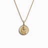 The Mini Cleopatra Necklace by Awe Inspired is a gold pendant necklace featuring an embossed ancient Egyptian pharaoh design on a circular medallion, capturing the timeless elegance reminiscent of Queen Cleopatra.