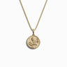 The Mini Harriet Tubman Necklace by Awe Inspired is a gold chain necklace featuring a round medallion pendant with an embossed image that symbolizes bravery, reminiscent of Harriet Tubman's courageous spirit and her pivotal role in the Underground Railroad.