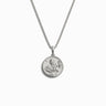 Awe Inspired’s Mini Harriet Tubman Necklace is a silver accessory featuring a round pendant engraved with the figure of Harriet Tubman, symbolizing her bravery and crucial role in the Underground Railroad.