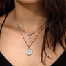 A woman wearing a Nyx Pendant by Awe Inspired with a moon and a star.