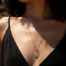 Model wearing round standard Nemesis Pendant on a box chain in gold vermeil