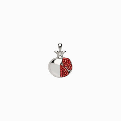 A silver and red Pomegranate Amulet pendant by Awe Inspired on a white background.