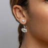 A woman wearing a single Awe Inspired Poppy Earrings in sterling silver