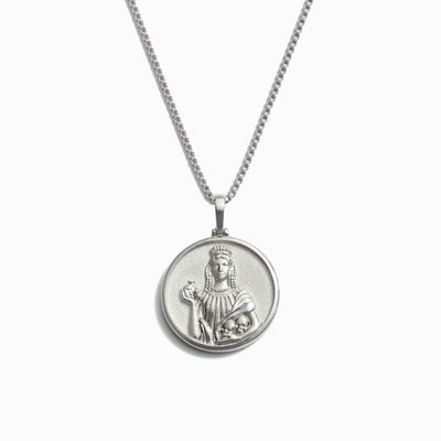 Awe Inspired's Persephone Necklace, a silver piece adorned with a round pendant showcasing a raised image of Persephone holding a child.