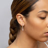 Model wearing a single Crystal Quartz Huggie Earring in sterling silver