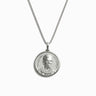 The Ruth Bader Ginsburg Necklace by Awe Inspired is a silver pendant necklace that features a medallion engraved with a portrait of the renowned seeker of justice, Ruth Bader Ginsburg, depicted wearing glasses and a necklace.