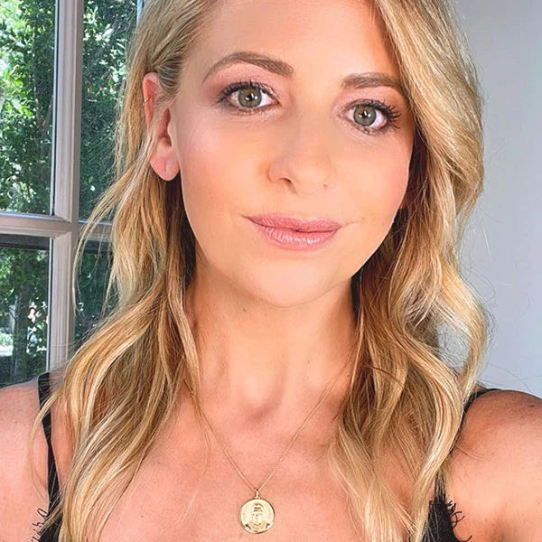 Sarah Michelle Gellar wearing Awe Inspired Ruth Bader Ginsburg Goddess coin necklace in gold