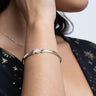 A woman wearing the Awe Inspired Triple Moon Cuff bracelet.