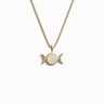 The Awe Inspired Triple Moon Necklace is a gold piece featuring a round white stone pendant flanked by two crescent moon shapes, symbolizing the Triple Moon and embodying divine feminine power.