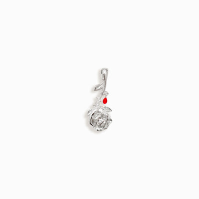 An Awe Inspired Diamond Rose Amulet with a red bead.