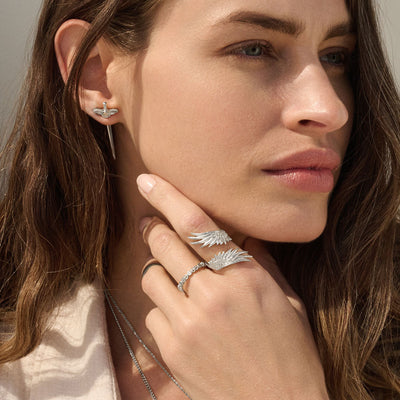 Model is wearing Diamond Triple Moon Band with Wing Wrap Ring and Flying Dagger Earrings.