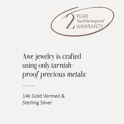 Image of a sign that reads: "Awe Inspired jewelry is crafted using only tarnish-proof precious metals: 14k Gold Vermeil & Sterling Silver." The sign also mentions a "2-Year 'You'll Be Inspired' Warranty, perfect for charm collectors who adore our Earth Magic Charm Bracelet.