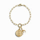 Awe Inspired's Inverted Moon Charm Bracelet features a gold chain with a lobster clasp, showcasing a circular medallion, crescent moon pendant, and small pearl charm.